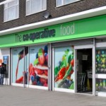 London East End Co operative food store with people queing at ATM machine
